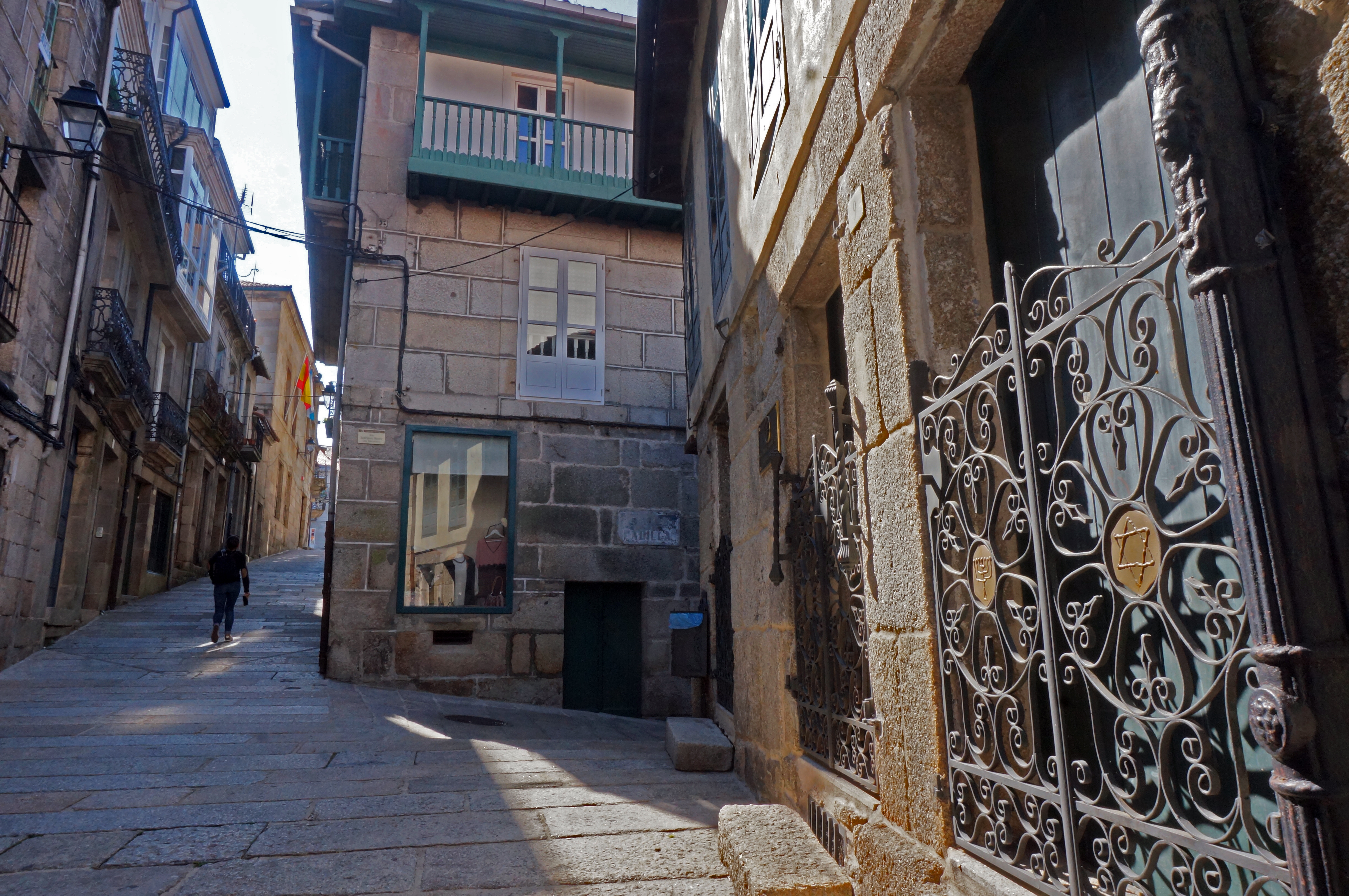 A tourist strolls past the old synagogue in the Spanish town of Ribadavia, Sept. 24, 2016. (Cnaan Liphshiz)