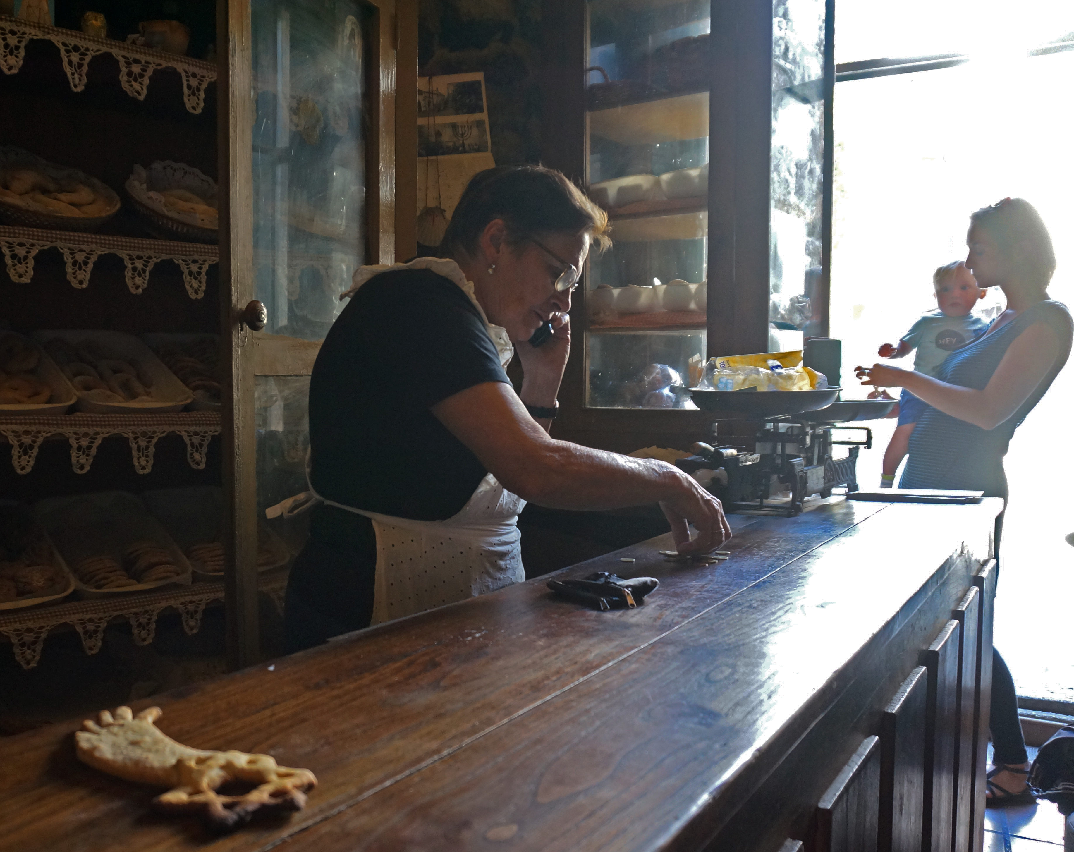 Herminia Rodriguez, left, prepares change for a customer at her Jewish bakery in Ribadavia, Spain, Sept, 24, 2016. (Cnaan Liphshiz)