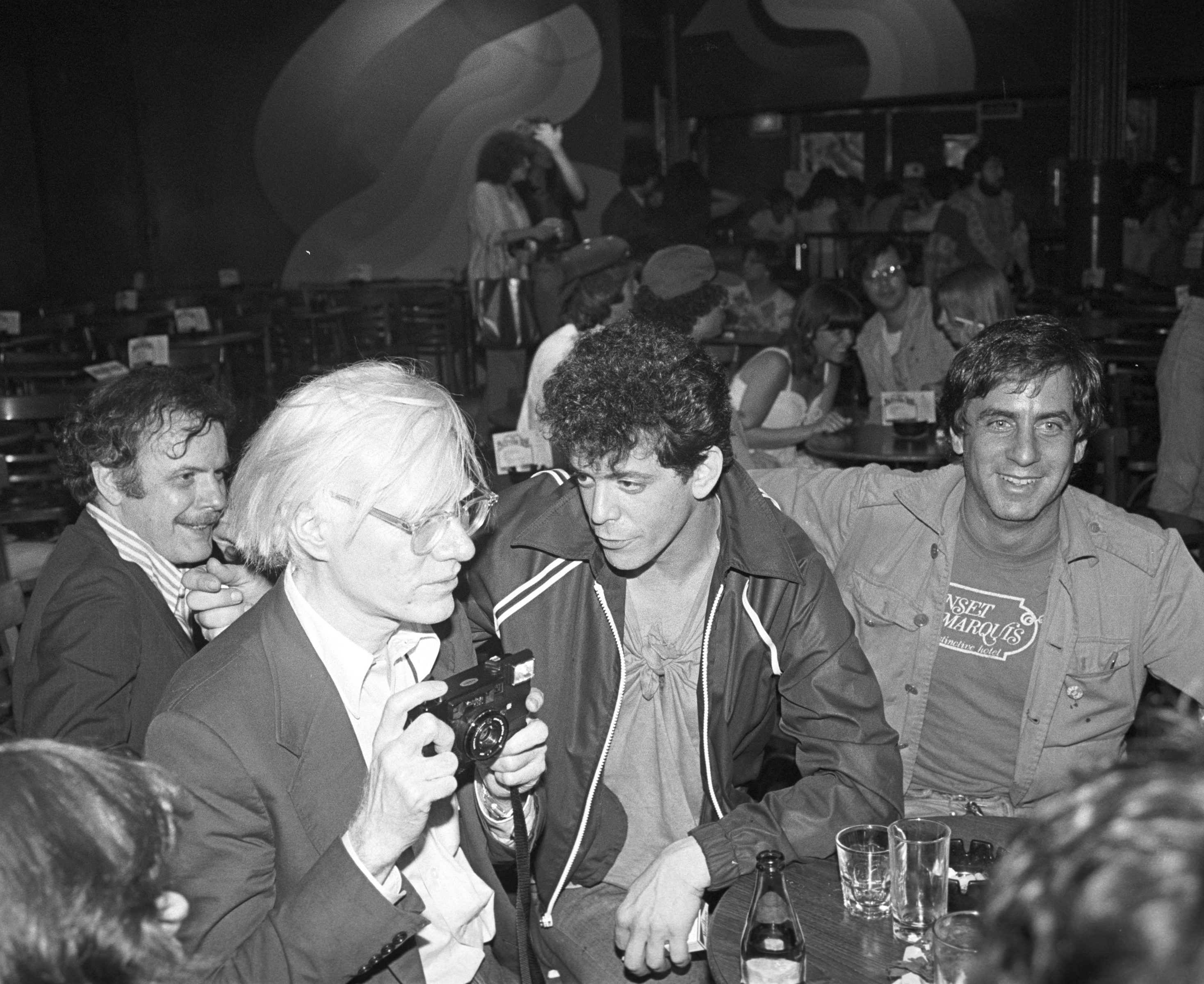 Danny Fields, right, with Andy Warhol, left, and Lou Reed, center, at a David Johansen show at the Bottom Line in New York City, July 20,1978. (Ebet Roberts/Redferns/Getty Images)