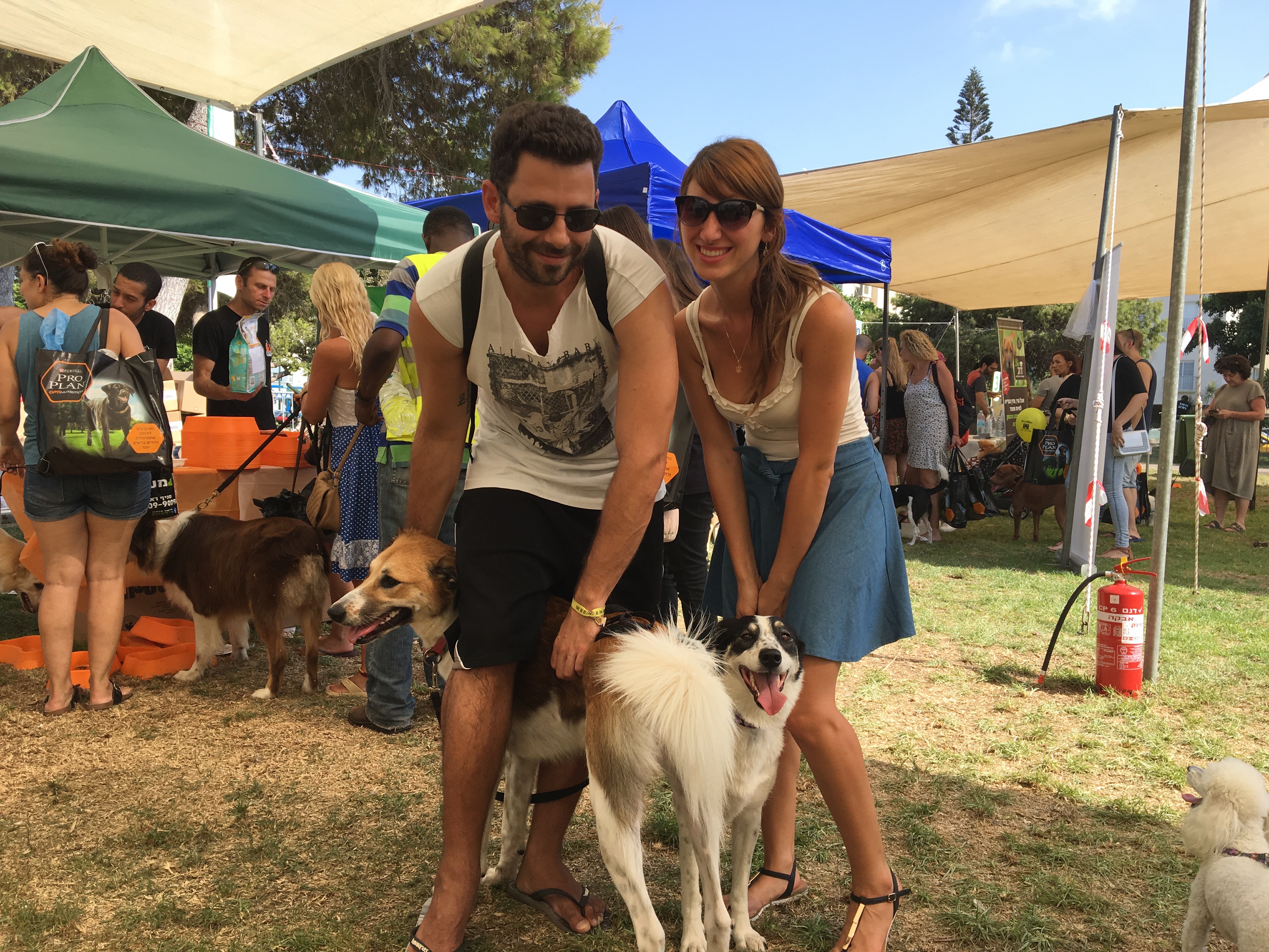 Hod Kashtan, left, with his dog Chuni, and Florencia Aventuriny with her dog Sandy at the Kelaviv dog festival in Tel Aviv, Aug. 26, 2016. (Andrew Tobin)