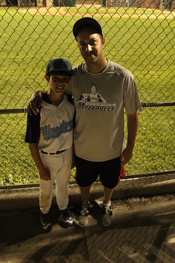 Jacob Steinmetz and his father, Elliott, walk to games on Shabbat -- but teammates take care of their gear and food. (Hillel Kuttler)