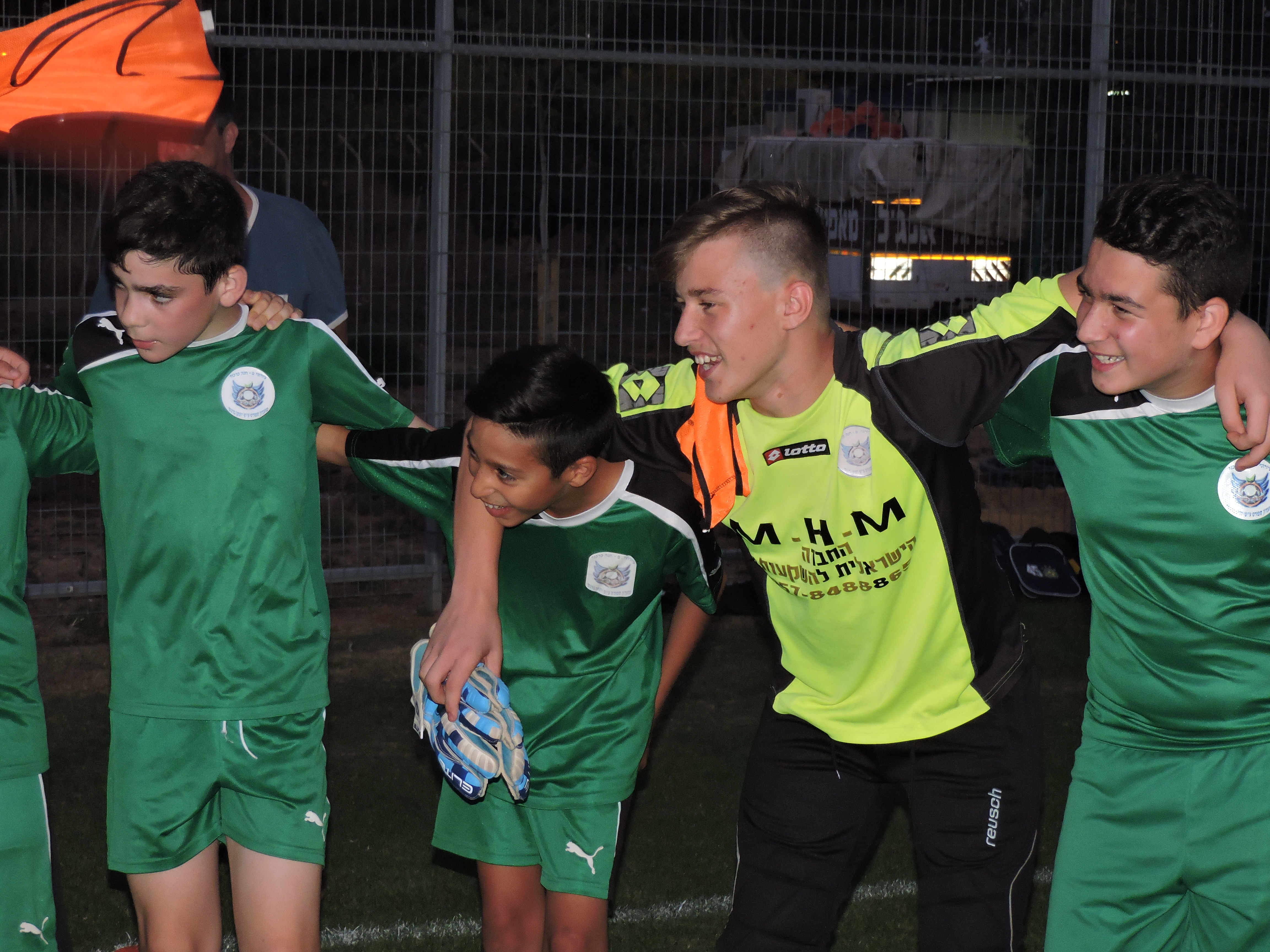 Members of the Tzav Pius 13-year-olds' team in the Israeli city of Pardes Hanna sing the team anthem following a practice. (Ben Sales)