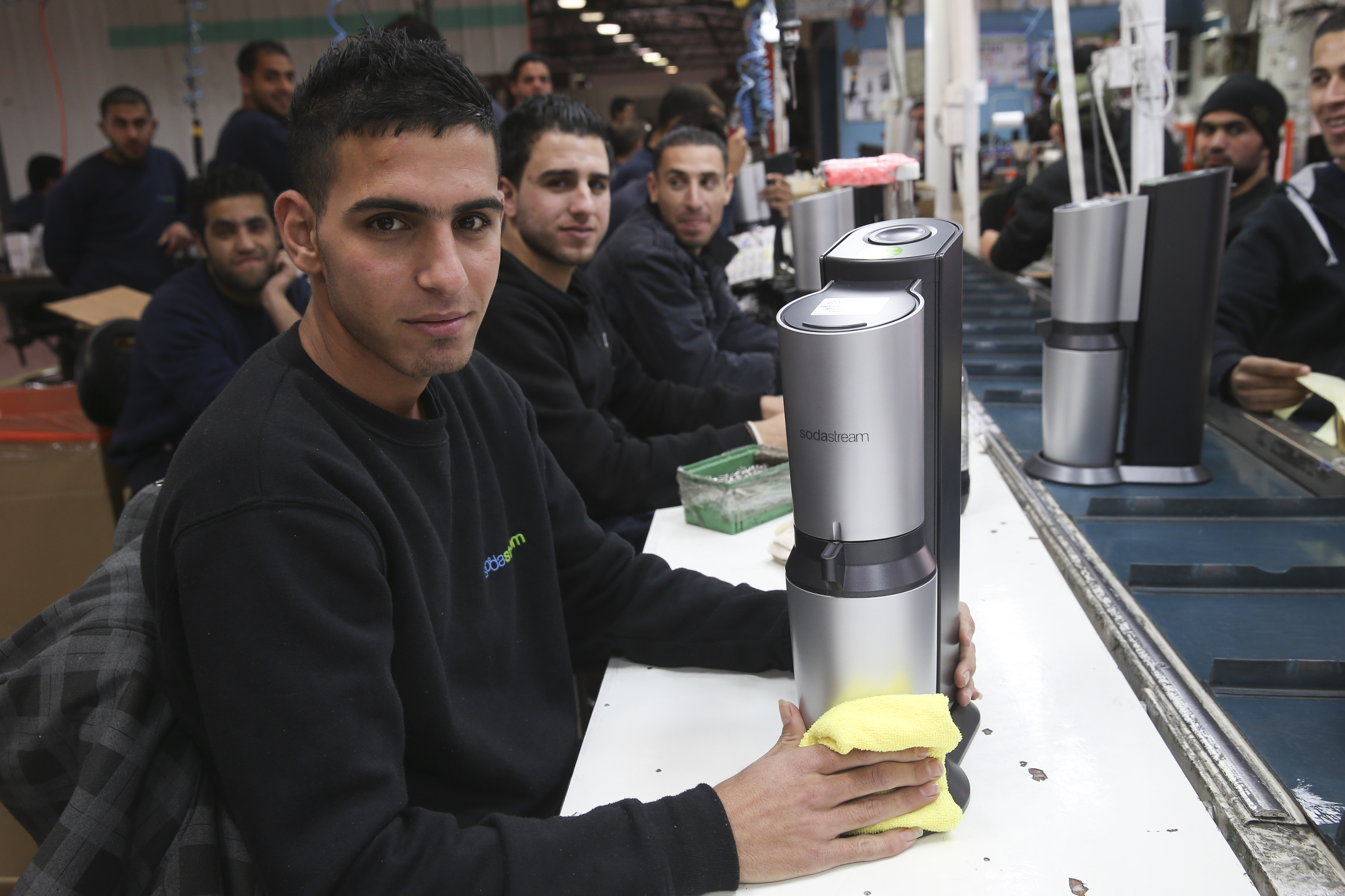 Some of the hundreds of Palestinians who work at SodaStream's West Bank factory that will be shit down. They could be put out of work with the facility's relocation to southern Israel. (Nati Shohat/Flash90)
