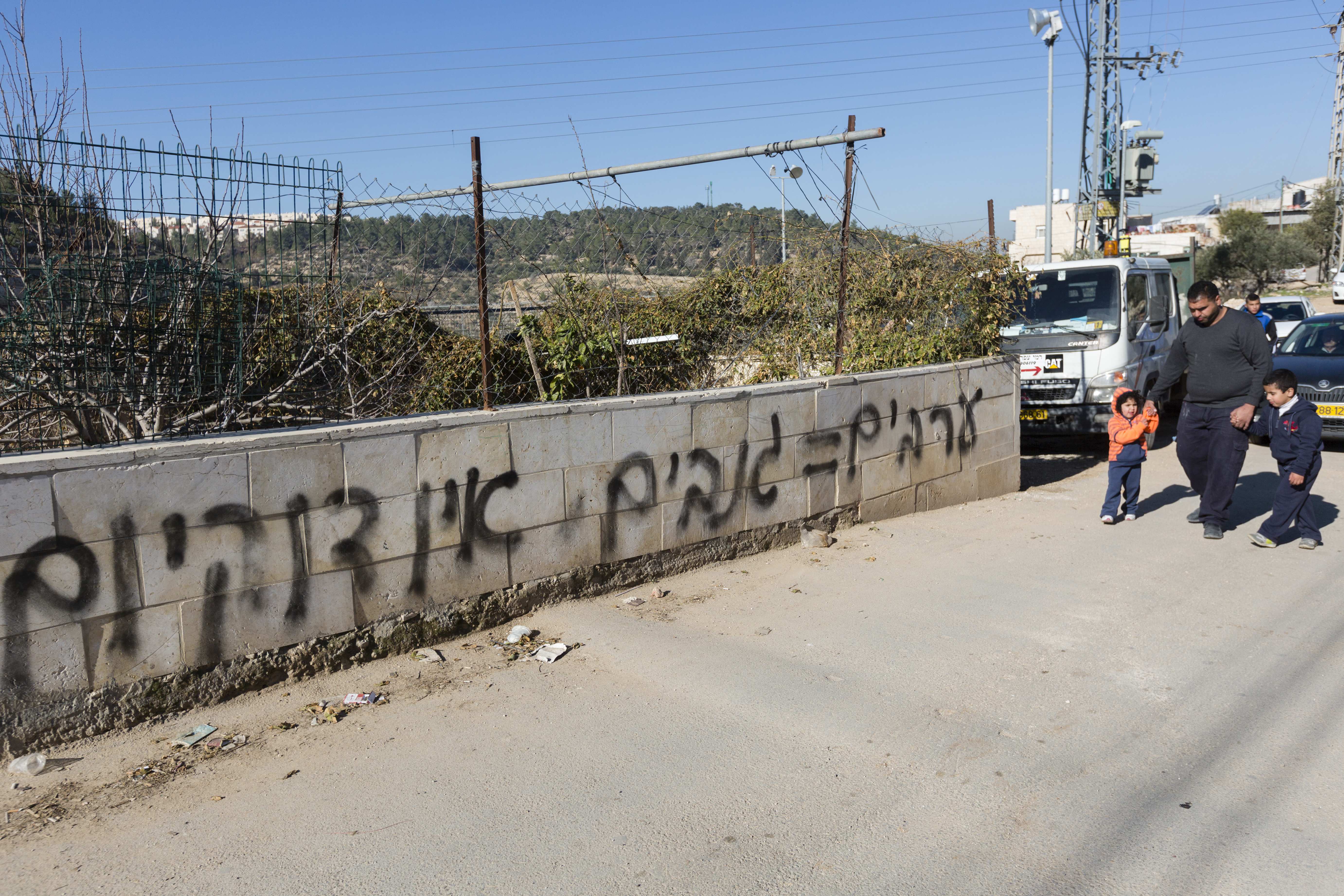 The New Israel Fund says it is getting more aggressive in combating xenophobia and ultrantionalism. This anti-Arab graffiti reads "Arabs=Thieves. No Coexistence" is seen spray-painted on a stone wall surrounding a house in the eastern Jerusalem neighborhood of Sharafat, Feb. 18, 2014. (FLASH90)