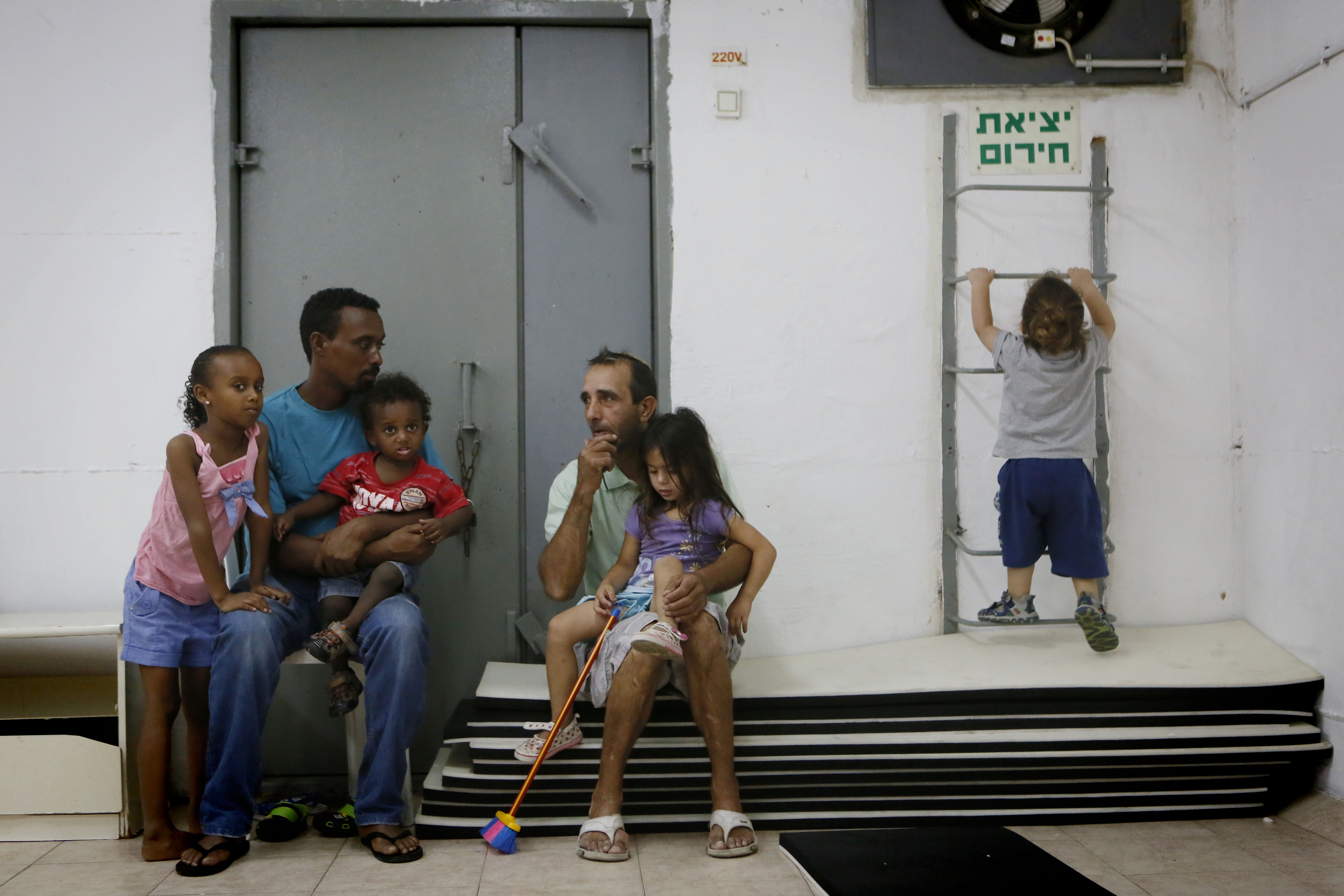 Israelis gather in a public bomb shelter in the southern city of Ashkelon, July 18, 2014. (Miriam Alster/Flash 90)