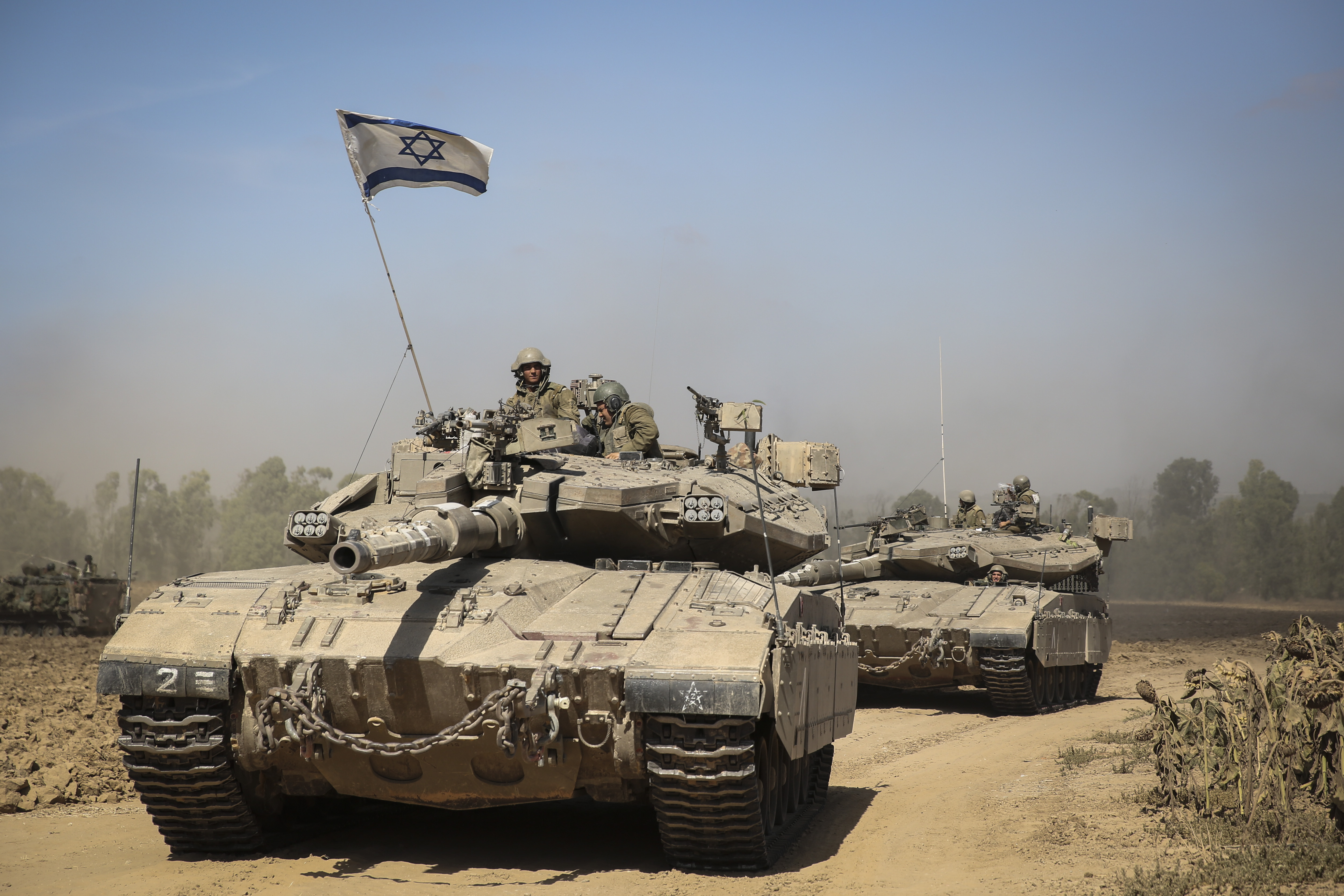 An Israeli tank crossing through a field in southern Israel near the border with Gaza, the day after Israel began its invasion of Gaza, July 18, 2014. (Hadas Parush/Flash 90)