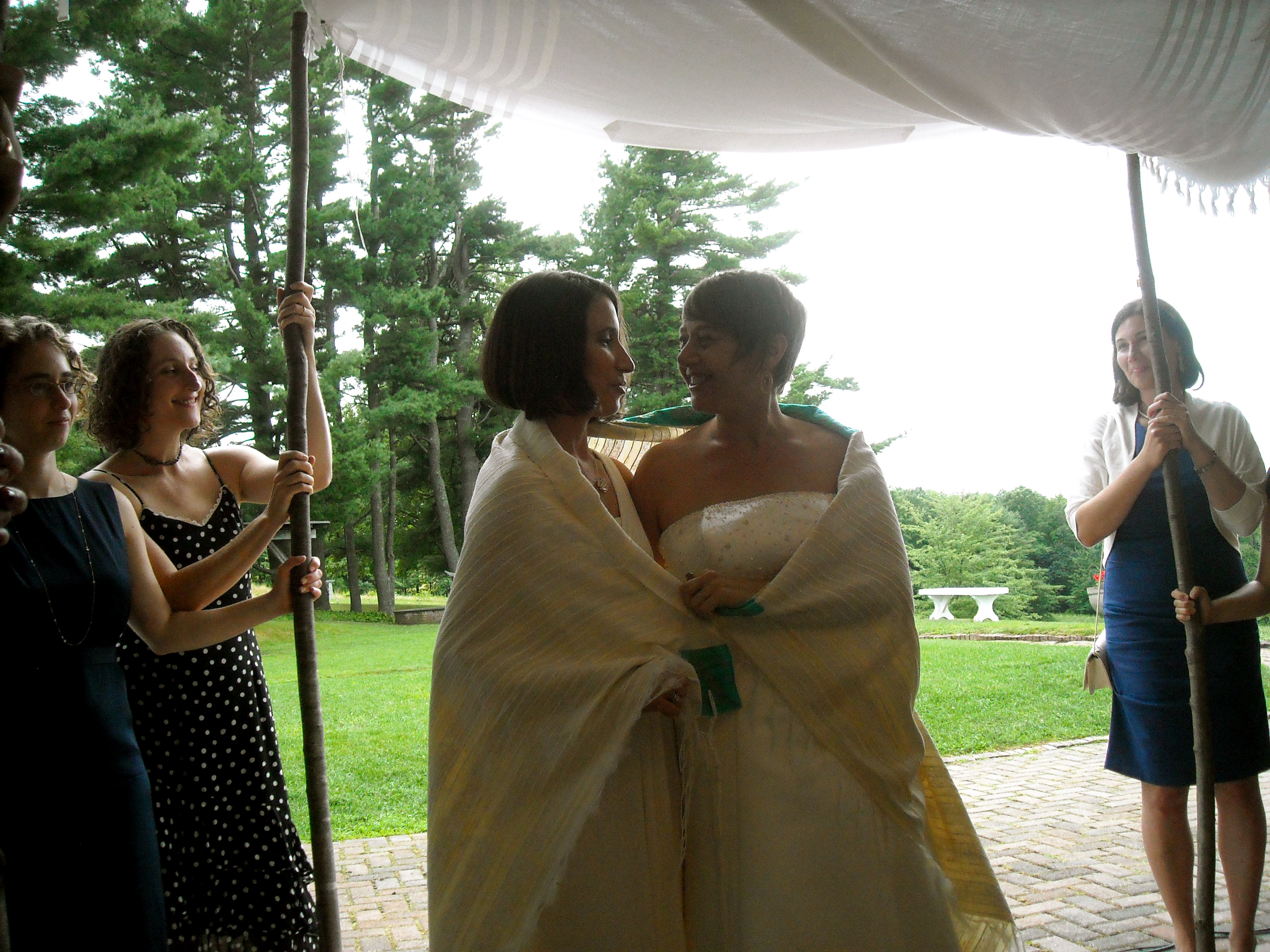 Idit Klein, right, the executive director of Keshet, married Jordan Namerow under a chuppah at their 2011 wedding in Massachusetts, which was officiated by two rabbis. (Courtesy of Idit Klein)