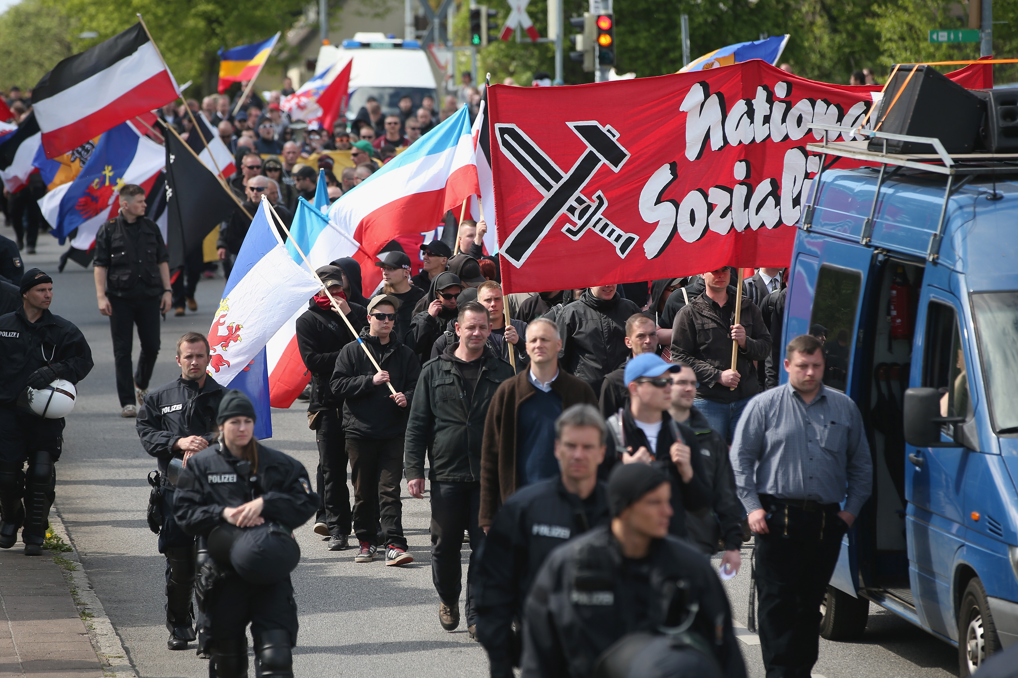 Some 250 supporters of the far-right National Democratic Party marching on May Day in Rostock, Germany, are accompanied by riot police, May 1, 2014. (Sean Gallup/Getty Images)