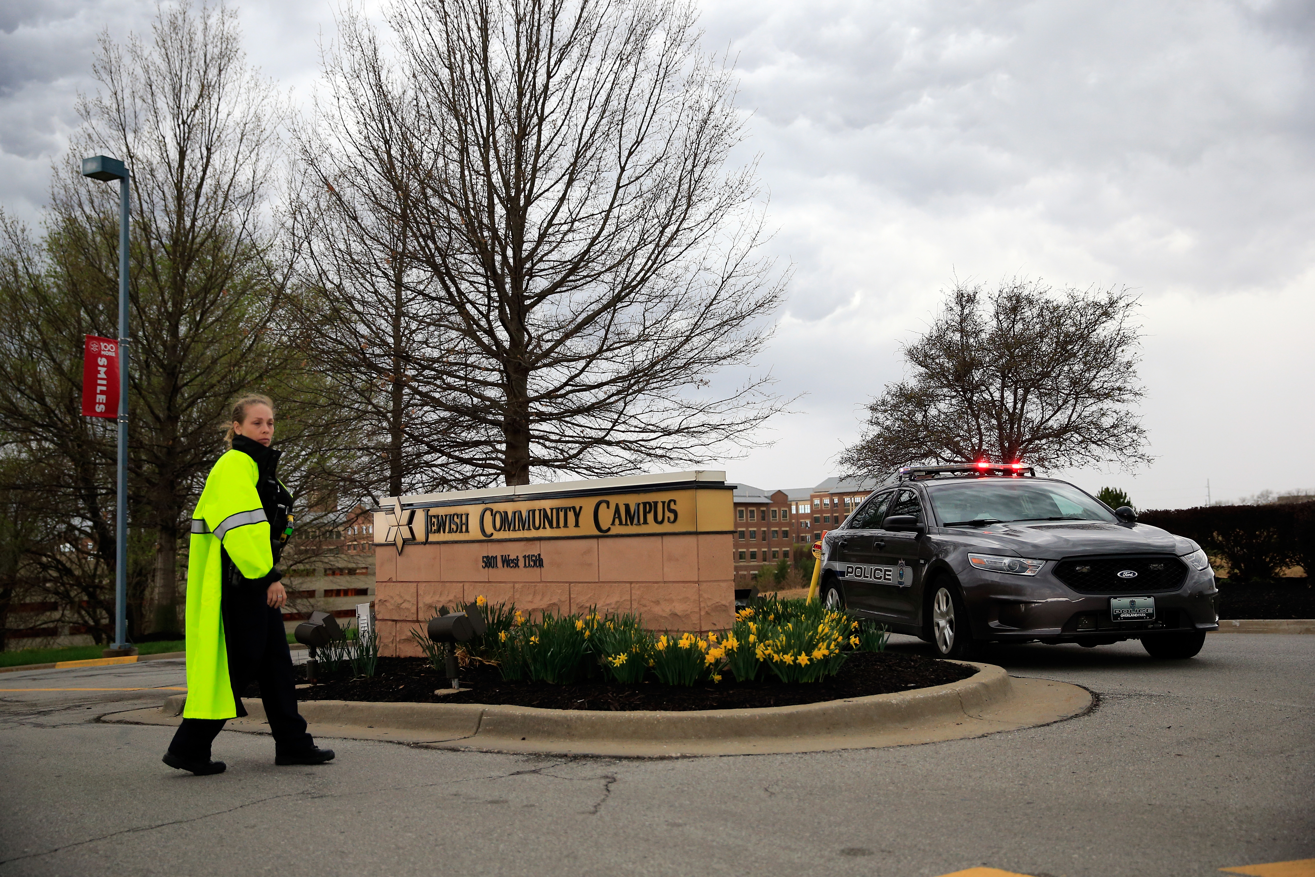 A policewoman and police car are seen at the entrance of the Jewish Community Center in Overland Park, Kan., following the fatal shootings there, April 13, 2014. (Jamie Squire/Getty Images)