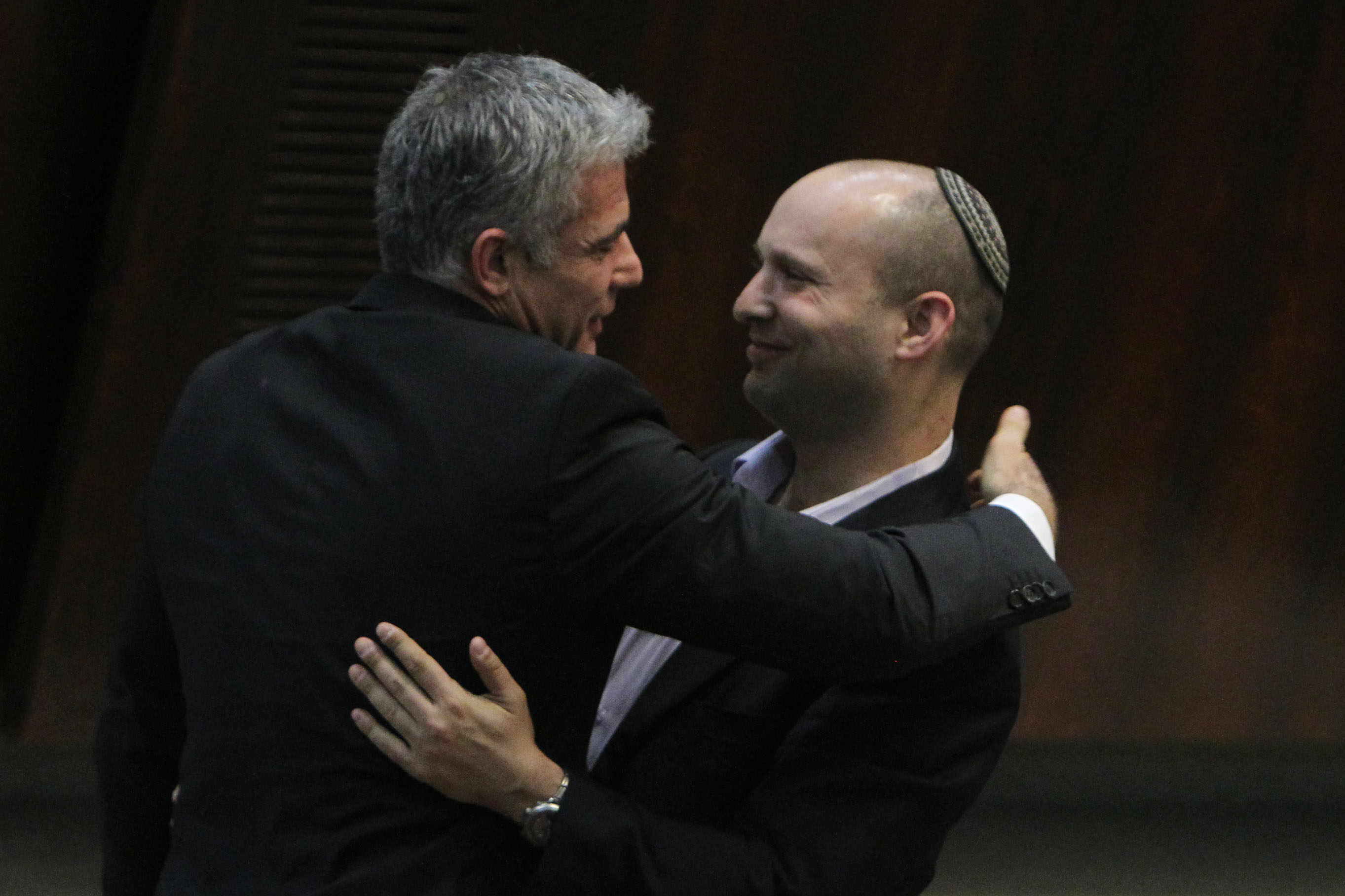Yesh Atid party leader Yair Lapid hugging Jewish Home party chief Naftali Bennett following Lapid's first speech at the Knesset, Feb. 11, 2013. (Miriam Alster/Flash90.JTA)