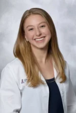 Smiling woman wearing a white doctor's coat